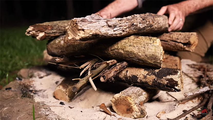 sticks stacked in a log cabin style for a log cabin fire build