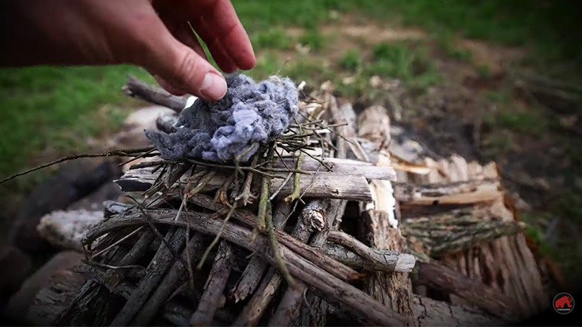 drier lint tinder on top of an upside down fire build. small sticks down to little sticks